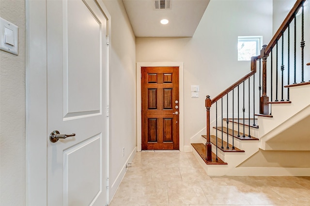 tiled entryway with stairway, baseboards, recessed lighting, and visible vents