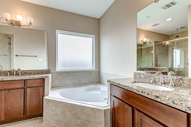 bathroom with a sink, two vanities, visible vents, a garden tub, and a stall shower