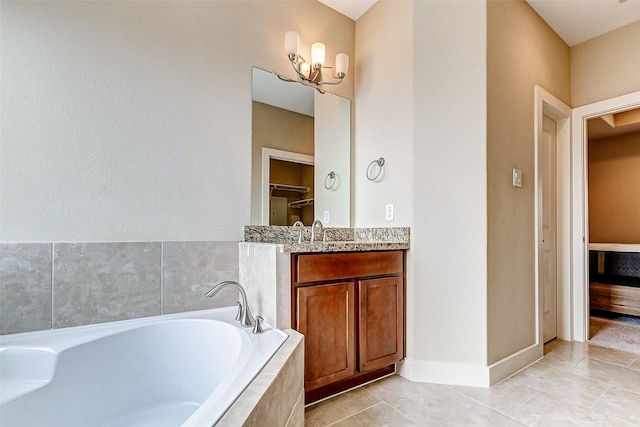 bathroom with vanity, tile patterned flooring, and a relaxing tiled tub