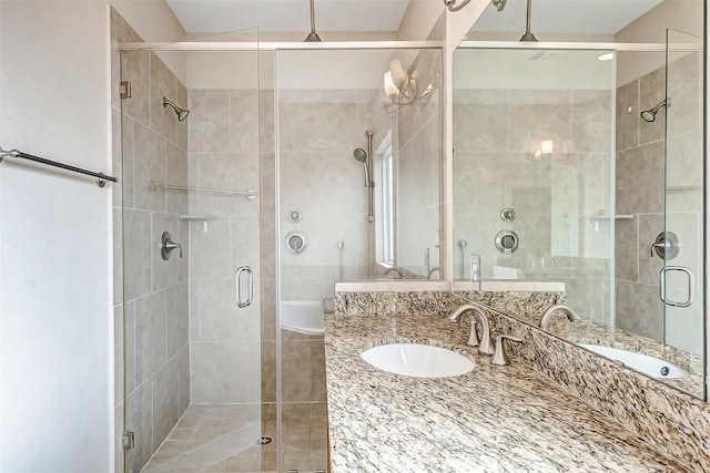 bathroom with vanity and a shower with door