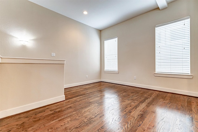 spare room featuring wood-type flooring