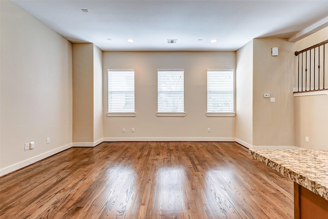 unfurnished room featuring dark hardwood / wood-style floors