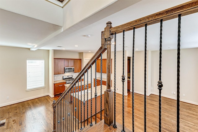 stairs featuring hardwood / wood-style flooring