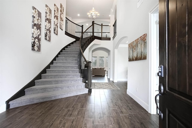 foyer featuring a towering ceiling and a chandelier