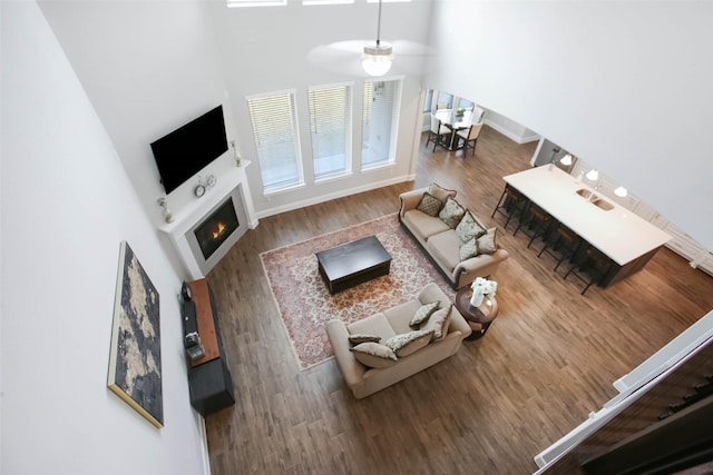 unfurnished living room with hardwood / wood-style flooring and a high ceiling