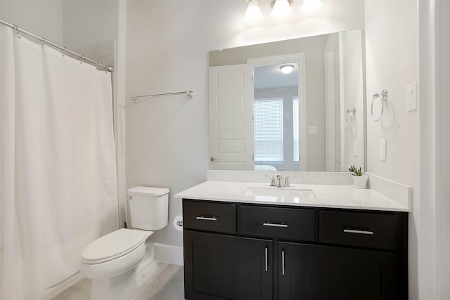 bathroom with vanity, toilet, and curtained shower