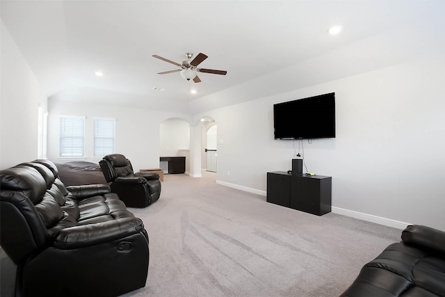 carpeted living room with ceiling fan