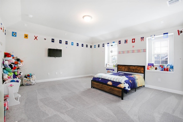 bedroom featuring light carpet