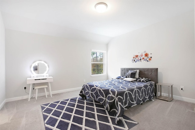 bedroom featuring lofted ceiling and carpet floors