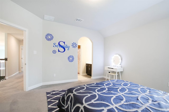 carpeted bedroom with lofted ceiling