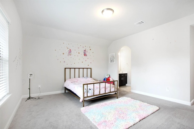 bedroom with carpet and lofted ceiling