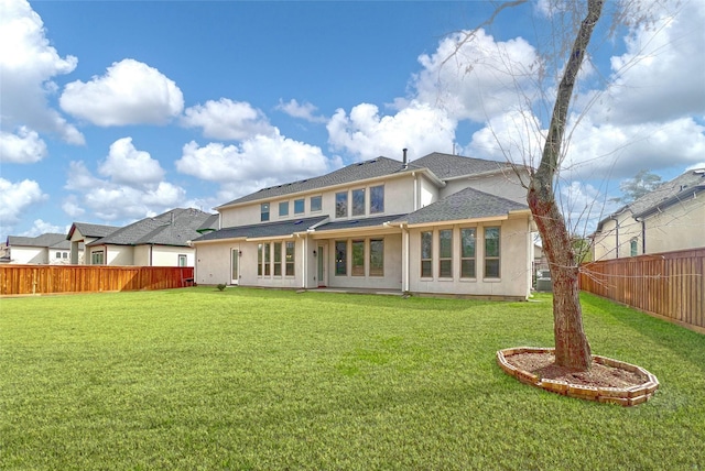 rear view of house with a yard