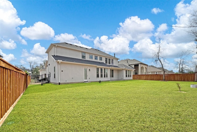 rear view of property featuring a yard