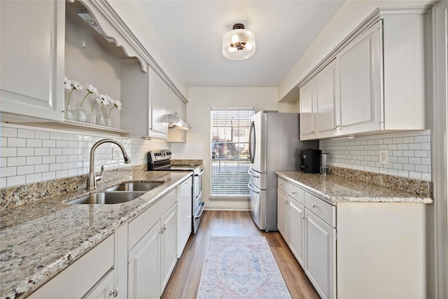 kitchen with white cabinetry, appliances with stainless steel finishes, sink, and light stone counters