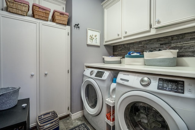 clothes washing area featuring cabinets and washing machine and dryer