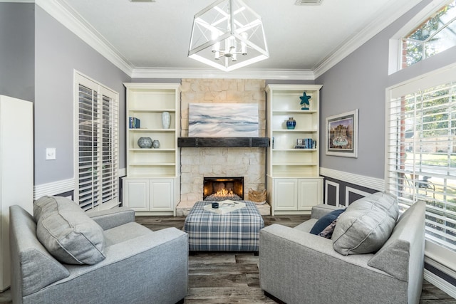 living room with crown molding, dark wood-type flooring, a stone fireplace, and a healthy amount of sunlight