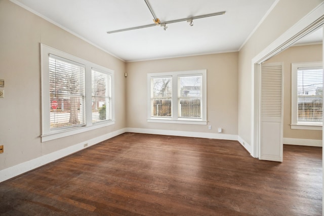 unfurnished room featuring plenty of natural light, dark wood-type flooring, and ornamental molding