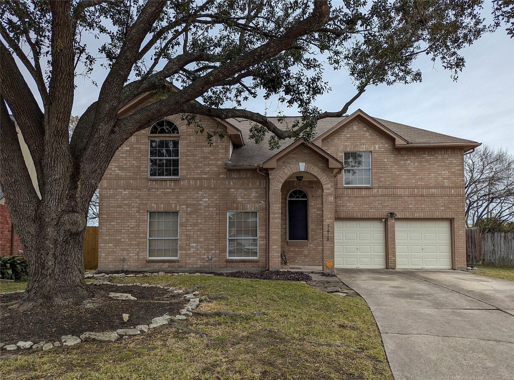 view of front facade with a garage and a front lawn