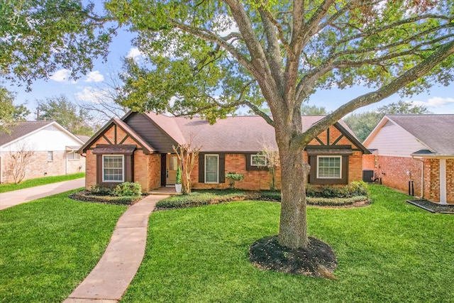 view of front of house featuring a front yard and central AC unit