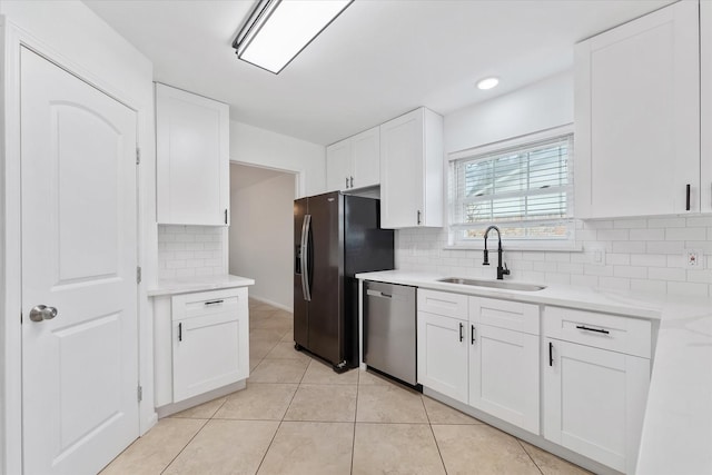 kitchen with sink, white cabinetry, light tile patterned flooring, black refrigerator with ice dispenser, and stainless steel dishwasher