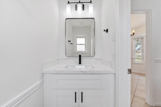 bathroom featuring vanity, tile patterned flooring, and a healthy amount of sunlight