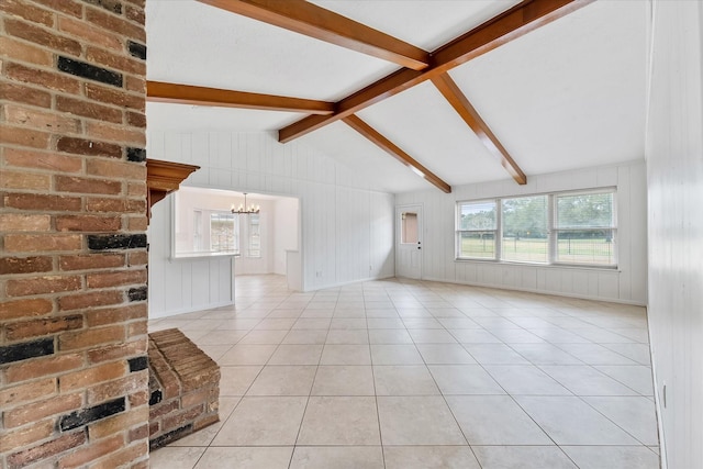 unfurnished living room with an inviting chandelier, lofted ceiling with beams, and light tile patterned floors