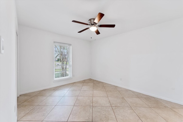 tiled spare room featuring ceiling fan