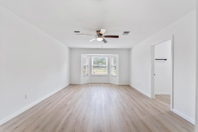 spare room featuring ceiling fan and light wood-type flooring