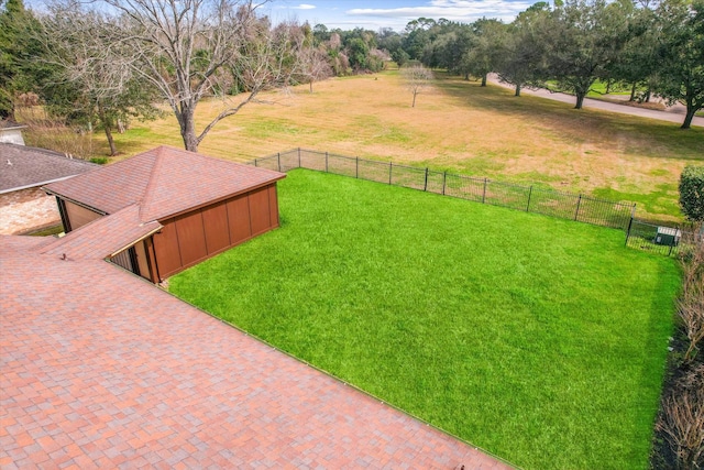 view of yard with an outdoor structure and a rural view