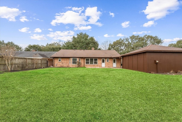 back of house featuring a yard