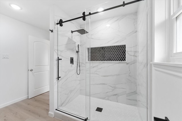 bathroom featuring wood-type flooring and a shower with shower door