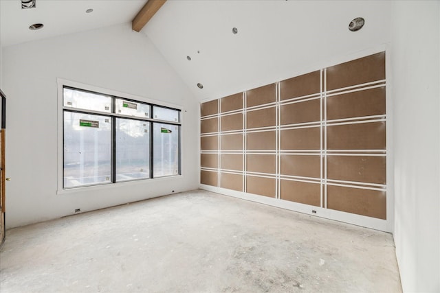 empty room with high vaulted ceiling, concrete floors, and beam ceiling