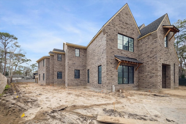 rear view of house featuring a garage