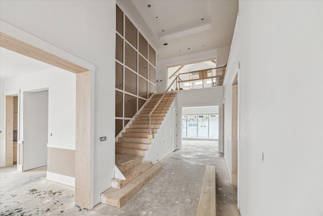 hallway featuring a towering ceiling