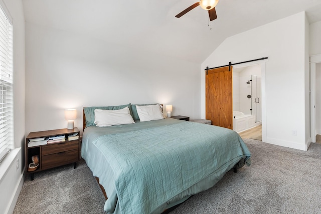 bedroom featuring ceiling fan, a barn door, vaulted ceiling, and carpet floors