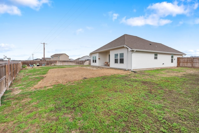 rear view of house featuring a lawn