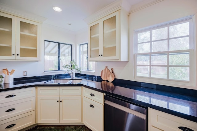 kitchen featuring dark countertops, glass insert cabinets, and a sink