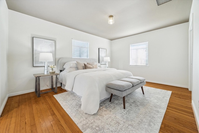 bedroom with wood finished floors and baseboards