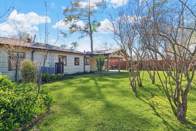 view of yard with fence and central AC