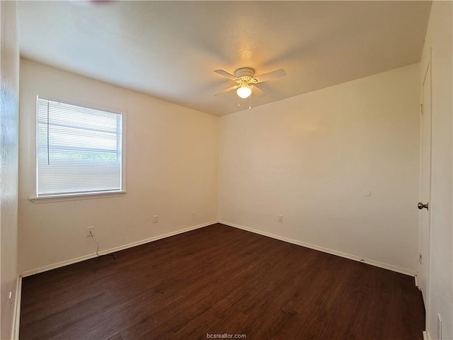 unfurnished room with dark hardwood / wood-style floors and ceiling fan