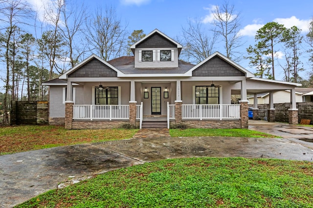 craftsman inspired home featuring a carport, ceiling fan, and a porch