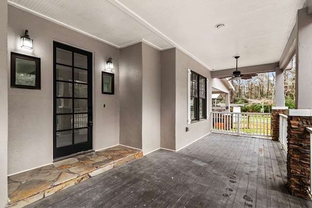 property entrance with a porch and ceiling fan