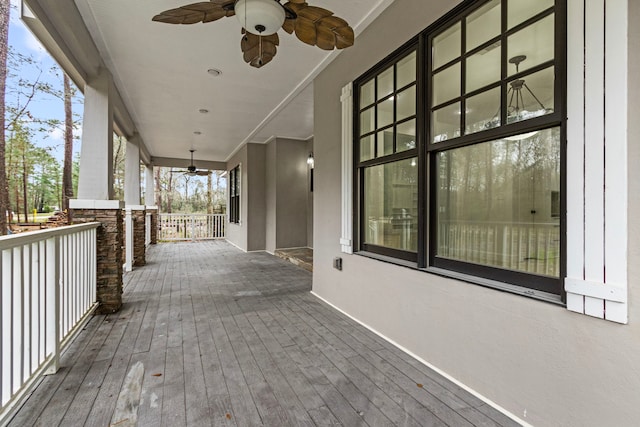 wooden terrace with ceiling fan and a porch