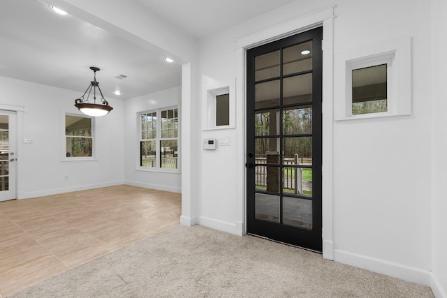 view of carpeted foyer entrance