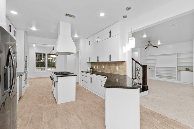 kitchen featuring white cabinetry, decorative light fixtures, a center island, and island exhaust hood