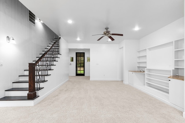 unfurnished living room with light carpet and ceiling fan