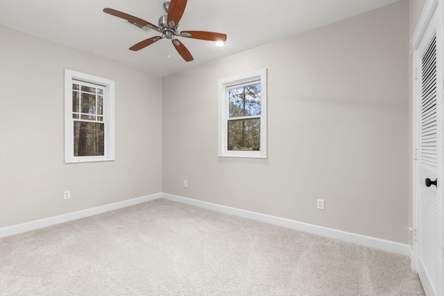 spare room with ceiling fan and carpet floors