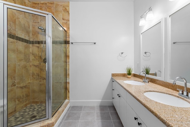 bathroom featuring tile patterned floors, a shower with shower door, and vanity