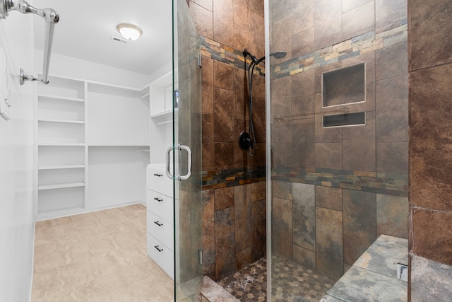 bathroom featuring a shower with door