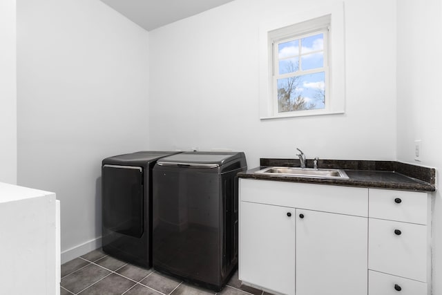 washroom featuring cabinets, washer and dryer, sink, and dark tile patterned floors